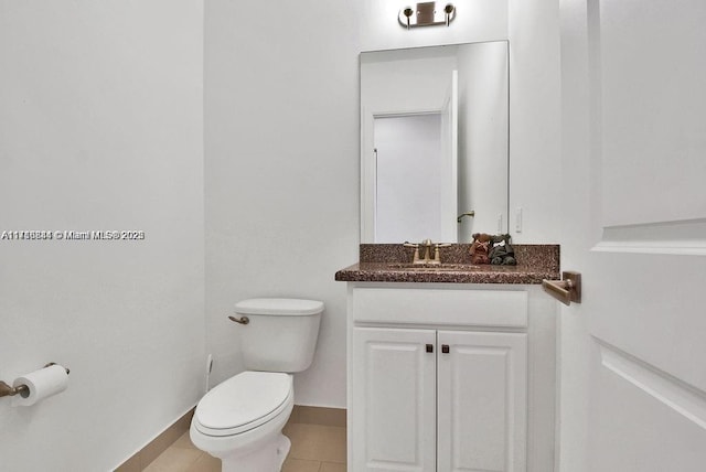 bathroom with tile patterned floors, vanity, and toilet