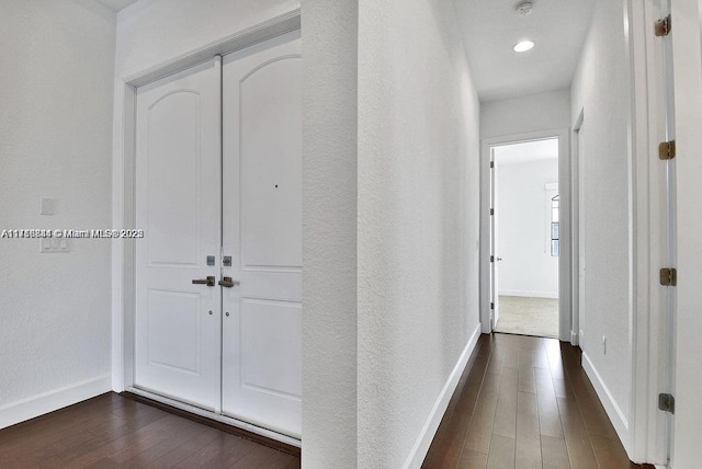 corridor with dark wood-type flooring