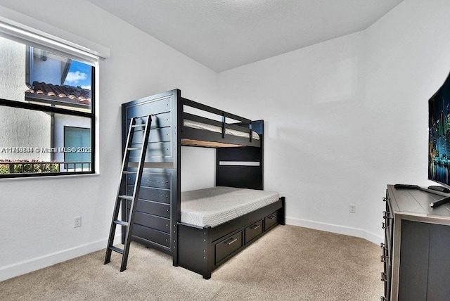 bedroom featuring light carpet