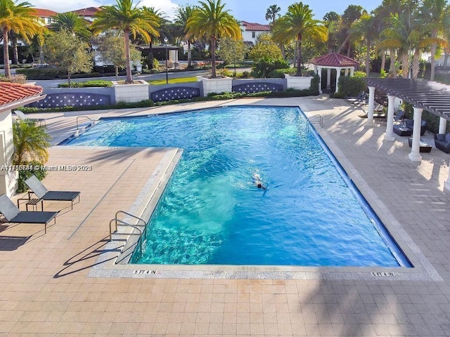 view of pool featuring a pergola and a patio