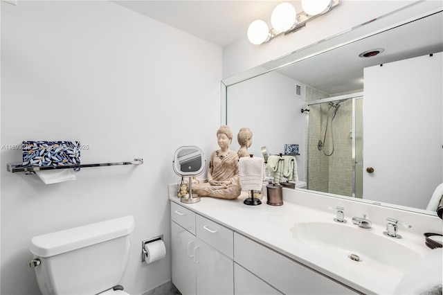 bathroom featuring visible vents, toilet, a stall shower, and vanity