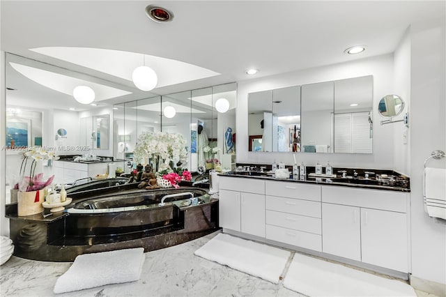 full bathroom with vanity, recessed lighting, marble finish floor, and a bathtub