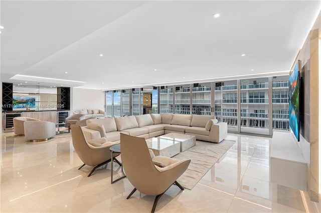 living room featuring floor to ceiling windows and beverage cooler