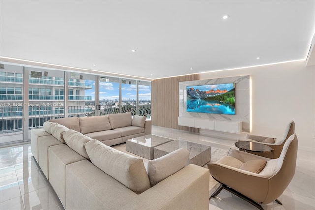 living room featuring a wall of windows and light tile patterned flooring