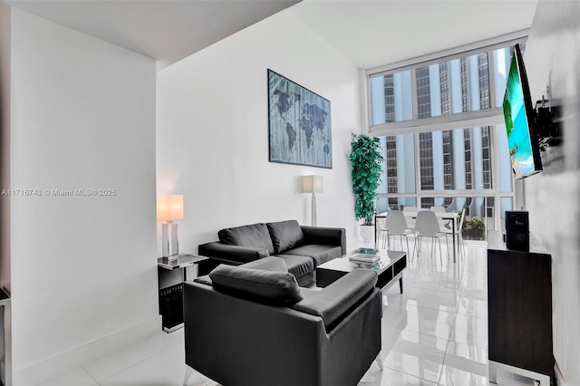 living room with light tile patterned floors and a wall of windows