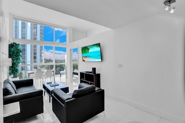 tiled living room featuring ceiling fan