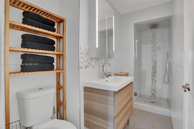 bathroom featuring an enclosed shower, vanity, toilet, and tile patterned floors