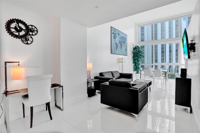 living room with expansive windows, a healthy amount of sunlight, and light tile patterned floors