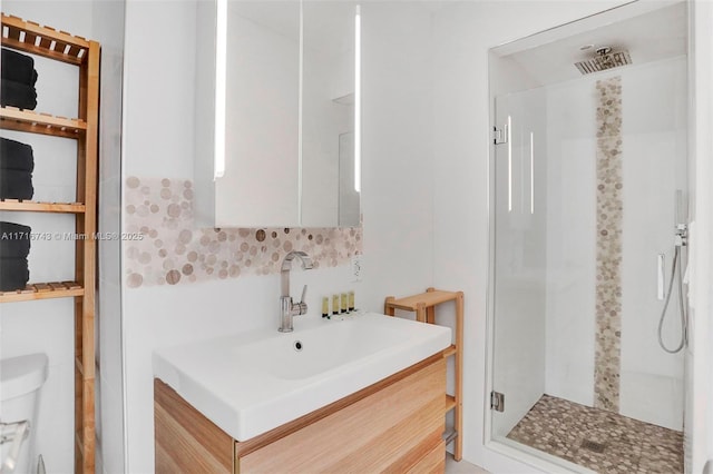 bathroom with vanity, a shower with shower door, and toilet