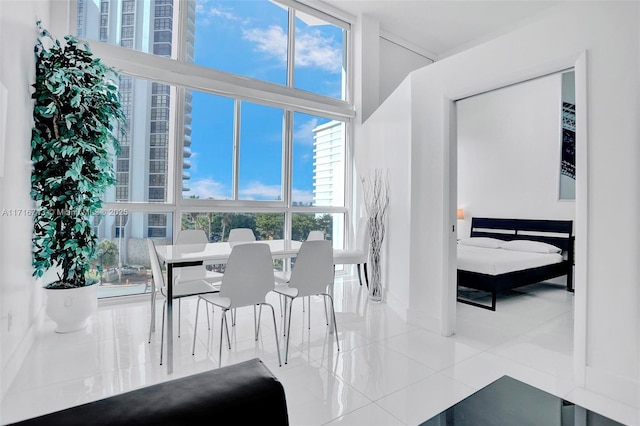 dining area with expansive windows, a wealth of natural light, and light tile patterned flooring