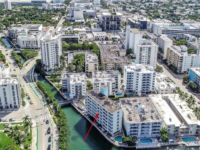 birds eye view of property featuring a water view and a city view