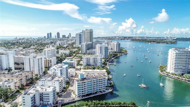 drone / aerial view featuring a water view and a city view