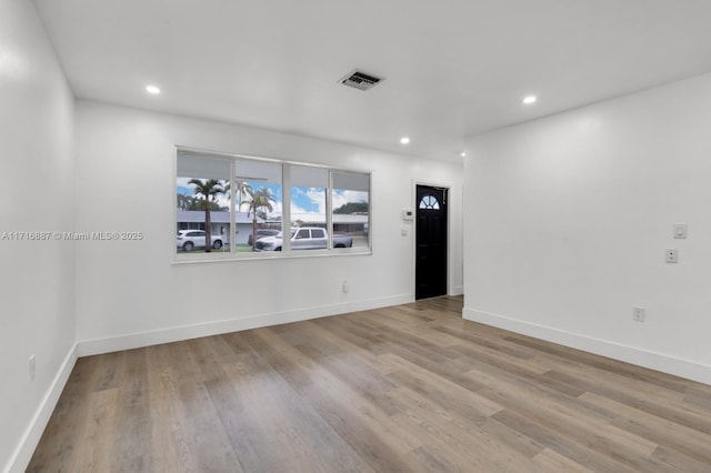 empty room with light hardwood / wood-style floors