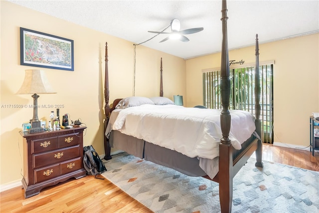 bedroom featuring ceiling fan, a textured ceiling, and light wood-type flooring