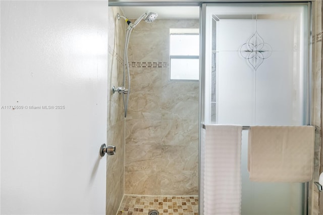 bathroom with a tile shower