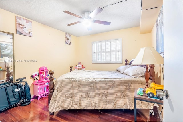 bedroom with ceiling fan, a textured ceiling, and hardwood / wood-style flooring