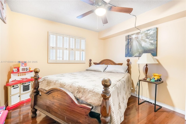 bedroom with hardwood / wood-style flooring and ceiling fan