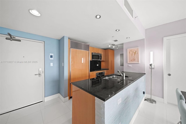 kitchen with light tile patterned flooring, appliances with stainless steel finishes, and sink