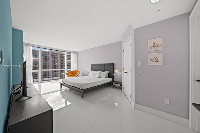 bedroom featuring floor to ceiling windows and light tile patterned flooring