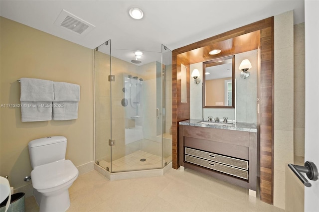 bathroom with a shower with door, vanity, and toilet