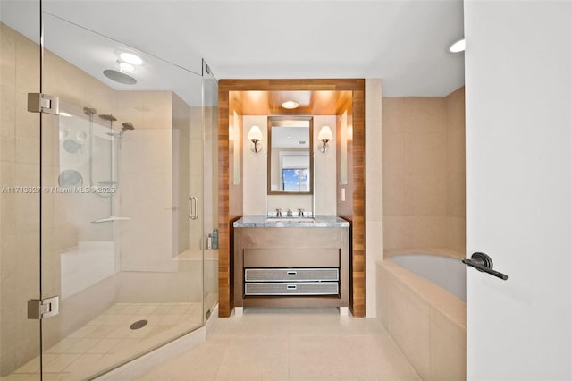 bathroom with tile patterned flooring, vanity, and independent shower and bath