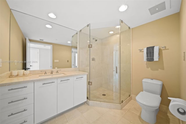 bathroom featuring tile patterned floors, vanity, toilet, and an enclosed shower