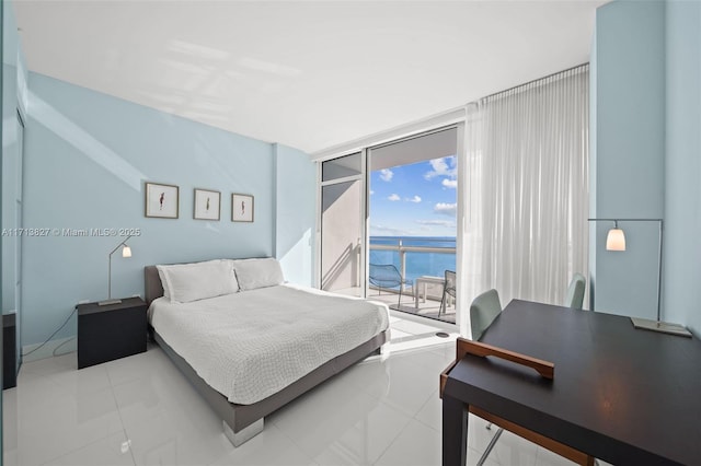 tiled bedroom with access to outside, a water view, and floor to ceiling windows