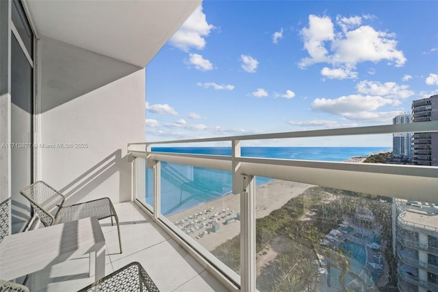 balcony with a view of the beach and a water view