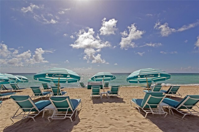 view of patio / terrace featuring a water view and a view of the beach