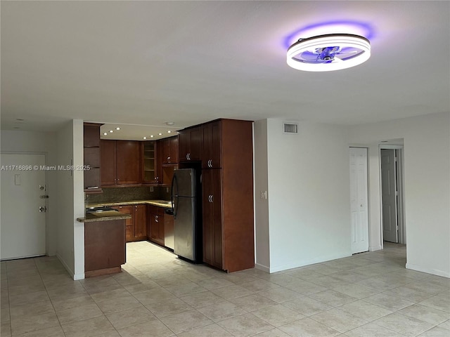 kitchen featuring appliances with stainless steel finishes and tasteful backsplash