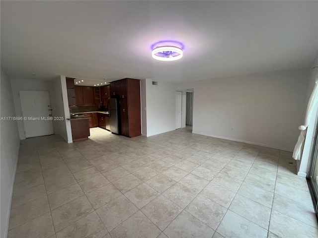 unfurnished living room with light tile patterned floors