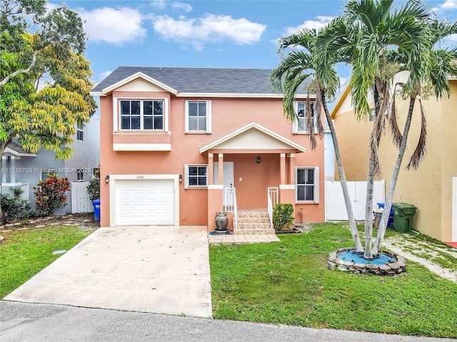 view of front of home featuring a front yard and a garage