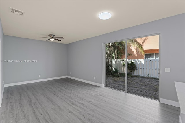 spare room with wood-type flooring and ceiling fan