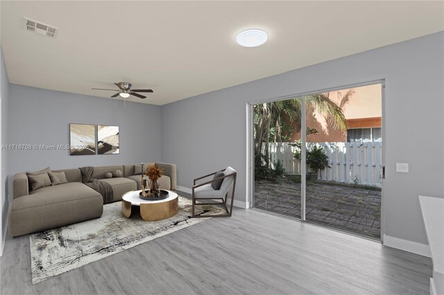 living room with hardwood / wood-style floors and ceiling fan