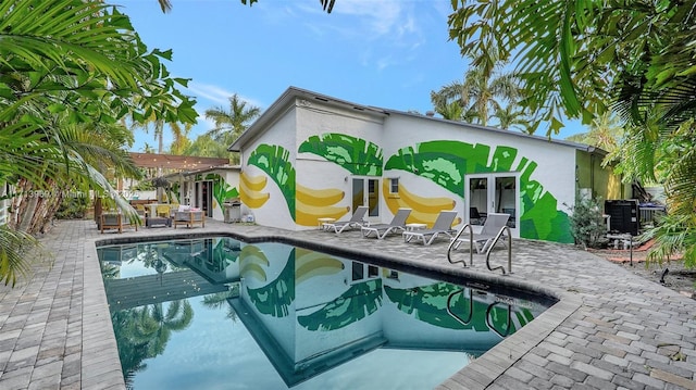 view of pool featuring french doors and a patio