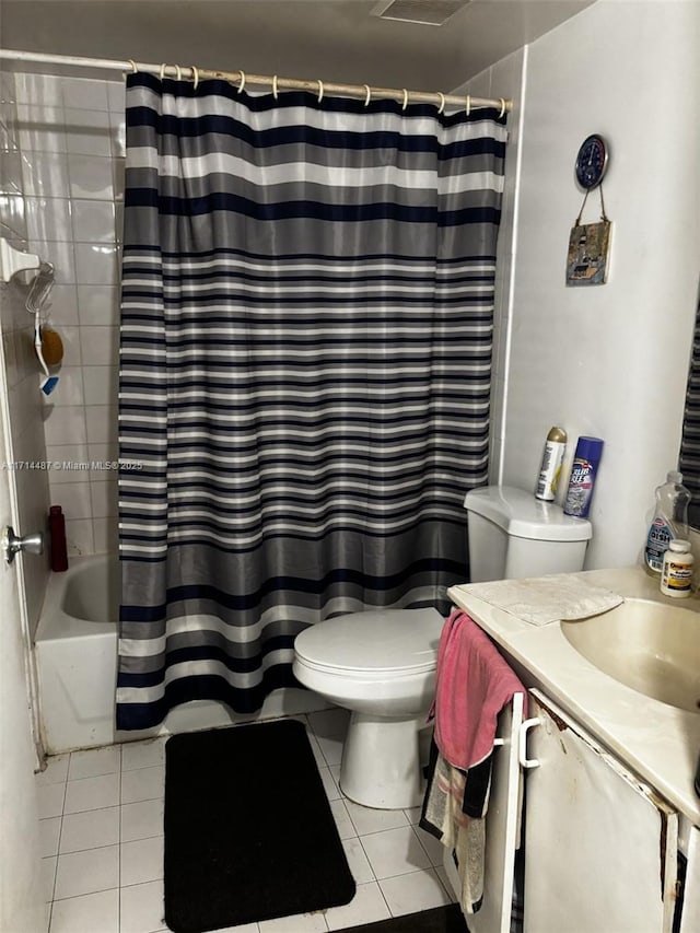 full bathroom featuring toilet, vanity, tile patterned floors, and shower / bathtub combination with curtain