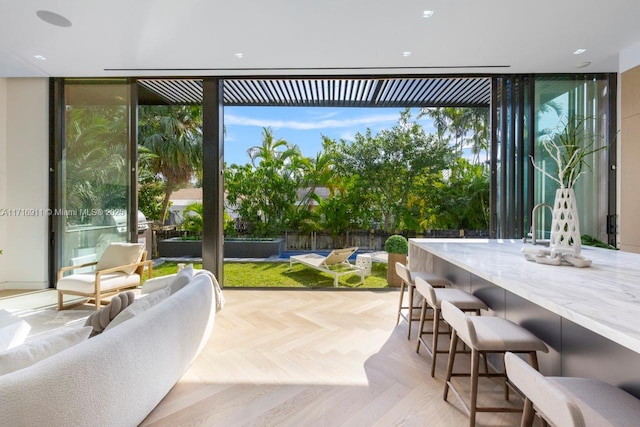 entryway with a healthy amount of sunlight, floor to ceiling windows, and light parquet flooring