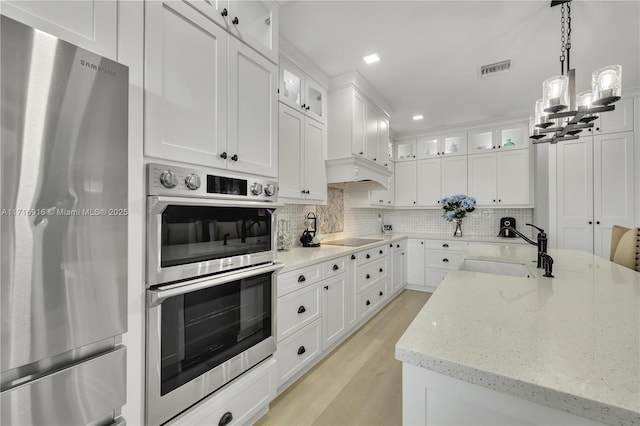 kitchen featuring sink, white cabinets, and stainless steel appliances