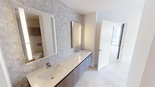 bathroom with tasteful backsplash, vanity, tile walls, and toilet