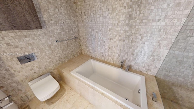 bathroom featuring toilet, tile walls, and a relaxing tiled tub