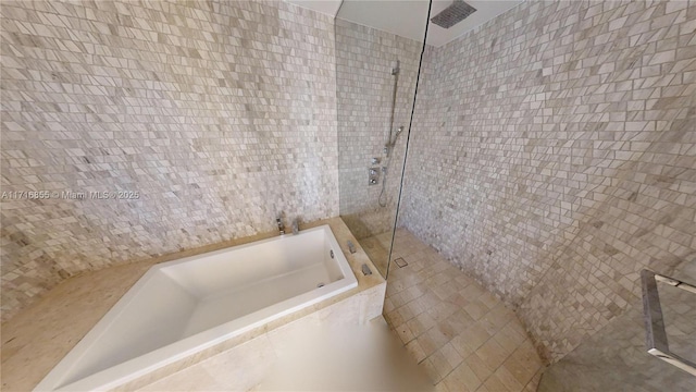 bathroom with separate shower and tub and tile walls