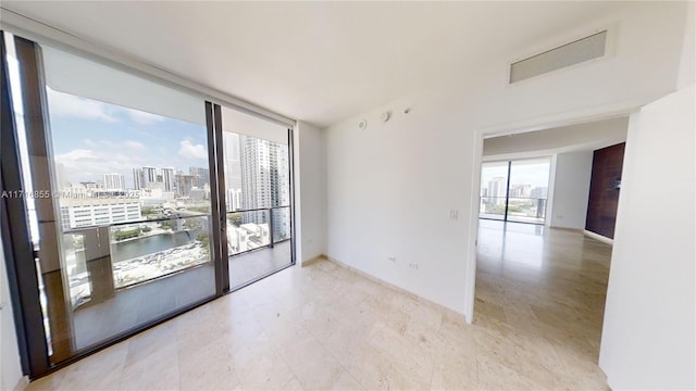 spare room with floor to ceiling windows