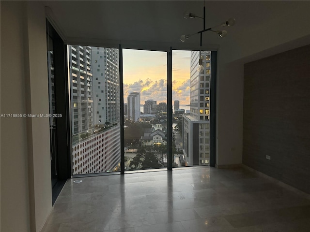 unfurnished room with a wall of windows