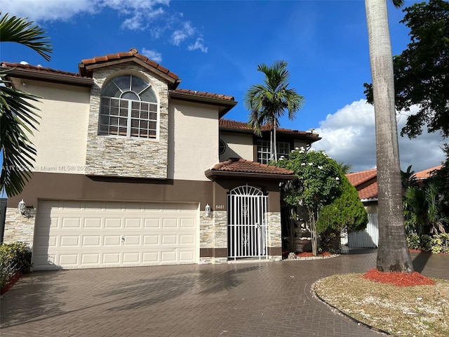 mediterranean / spanish house featuring a garage