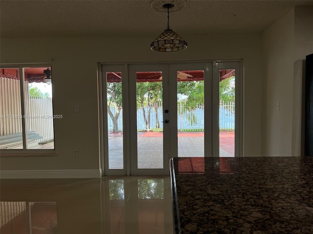 doorway to outside with french doors and a water view