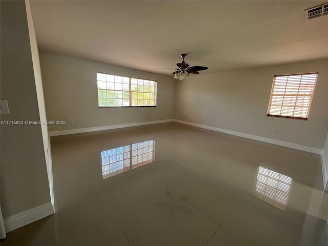 spare room featuring ceiling fan and tile patterned flooring