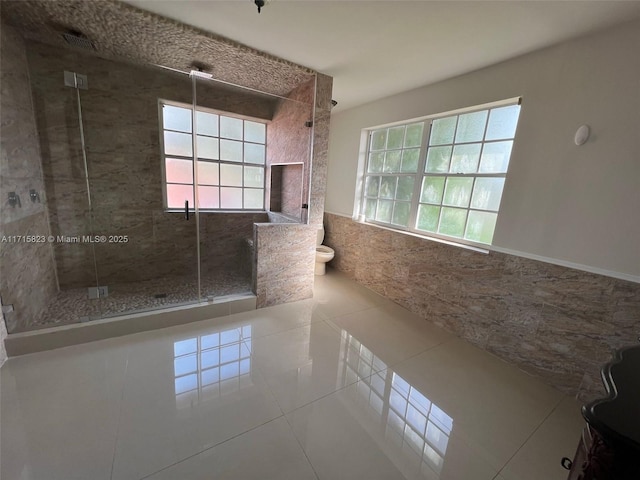 bathroom featuring tile patterned flooring and a shower with door