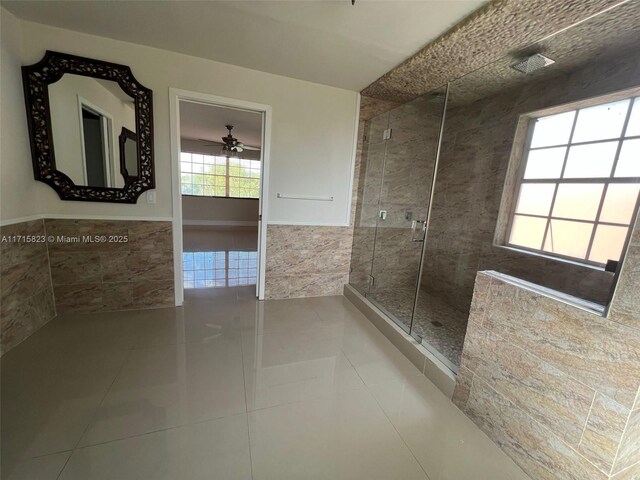 bathroom featuring tile patterned floors, ceiling fan, tile walls, and walk in shower