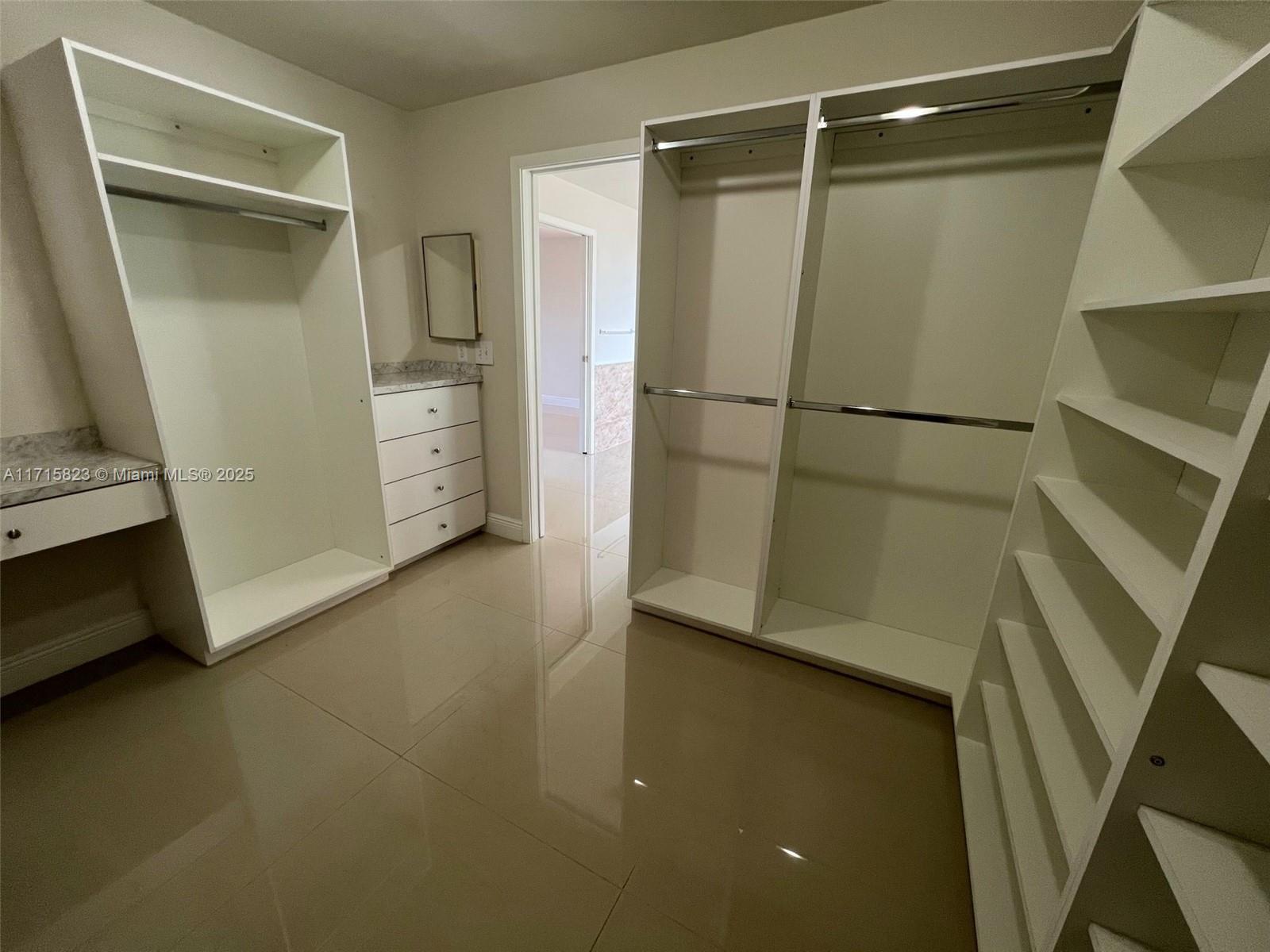 walk in closet featuring light tile patterned flooring