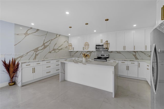 kitchen with white cabinets, decorative light fixtures, a kitchen island, light stone counters, and stainless steel appliances